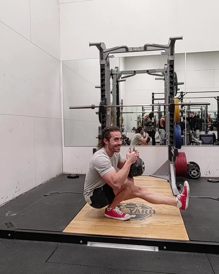 Nick using a kettlebell during a pistol squat